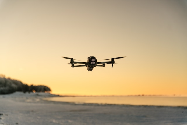 Compact camera drone flying during sunset photography