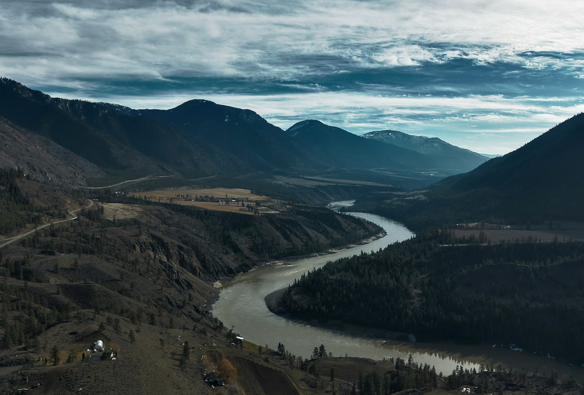 Drone aerial landscape photograph of mountains and river valley